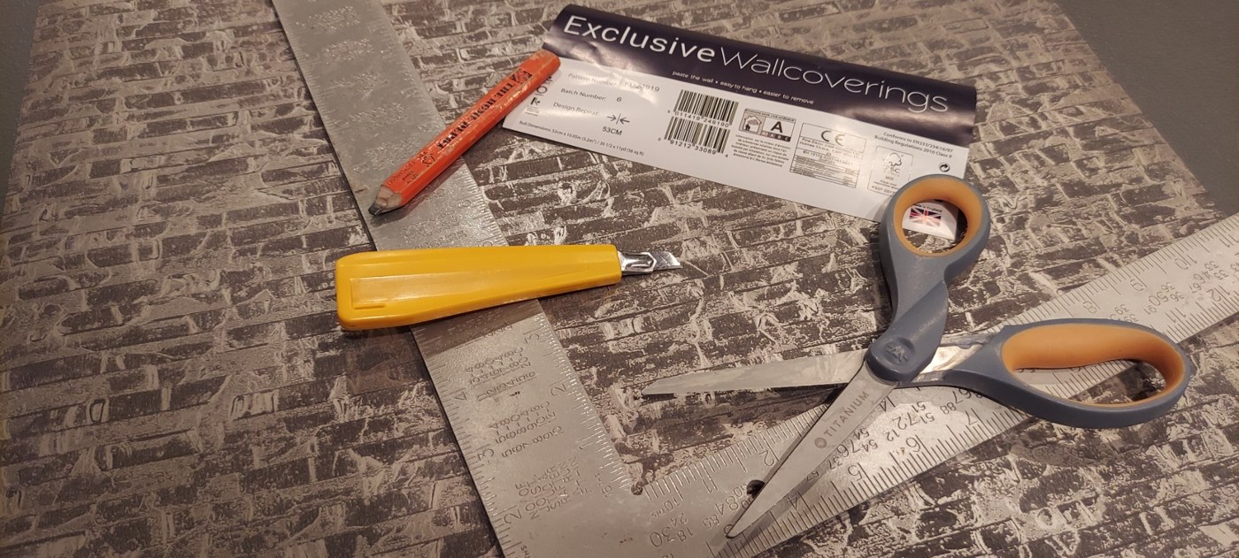 Wallpapering tools arranged on a work surface